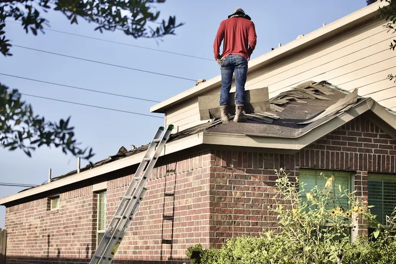 Professional roofer working on a residential roof in Austin Village